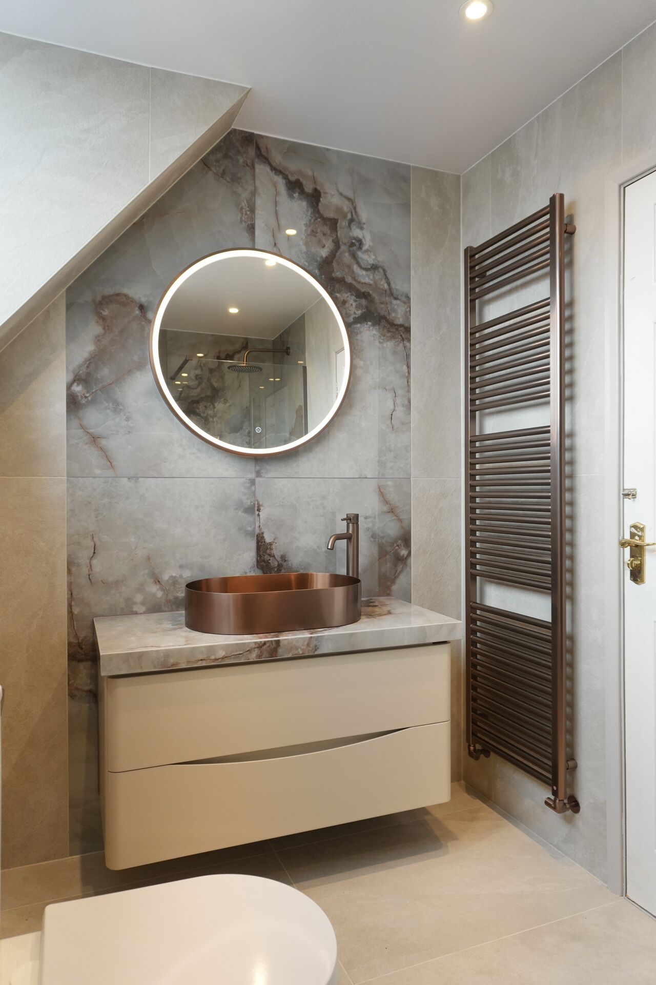 Copper basin set into a marble vanity