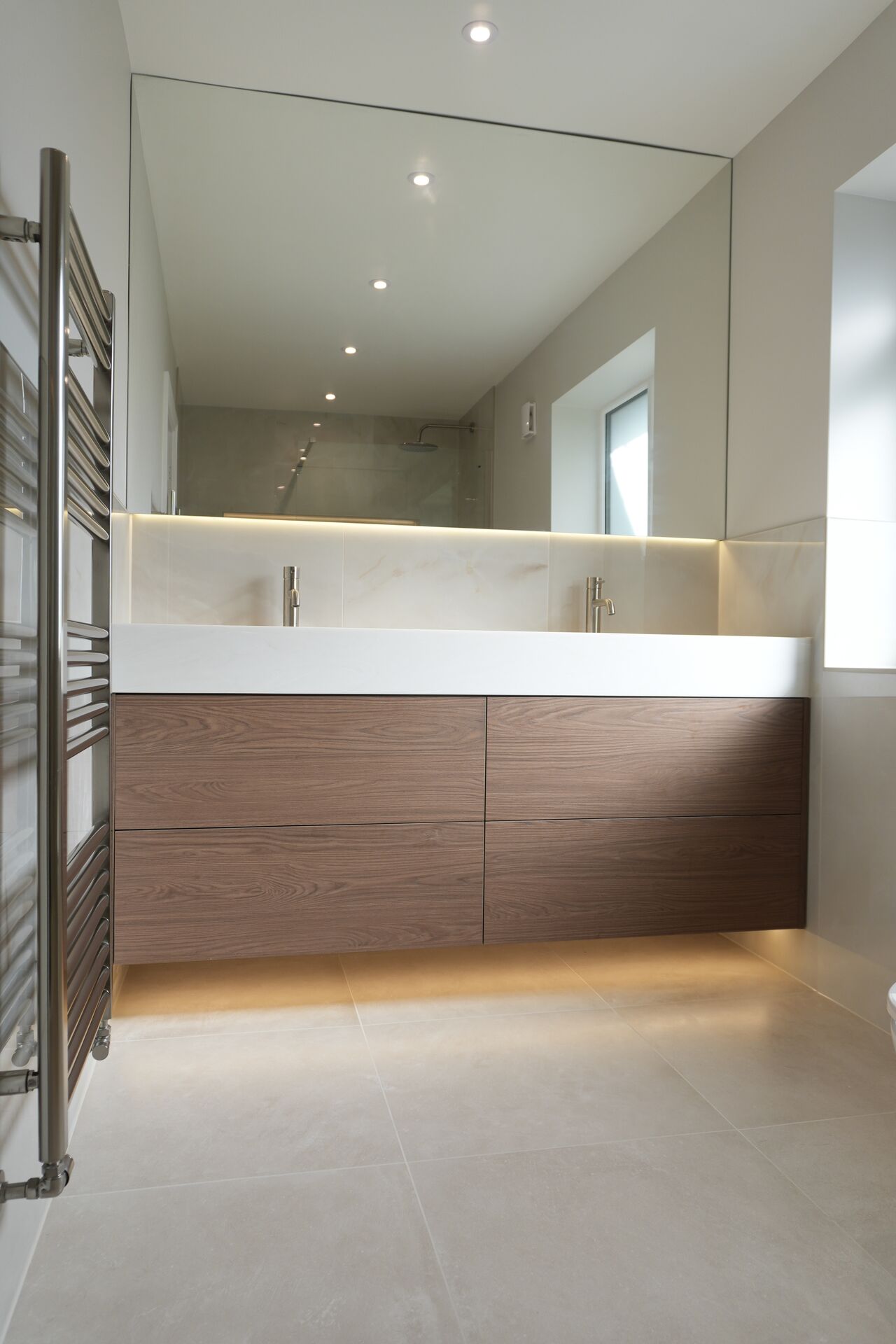 Walnut double vanity with backlit mirror